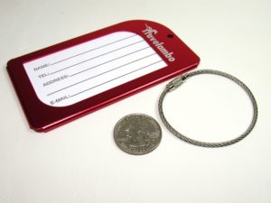 Metal aluminum luggage tag review photo next to quarter