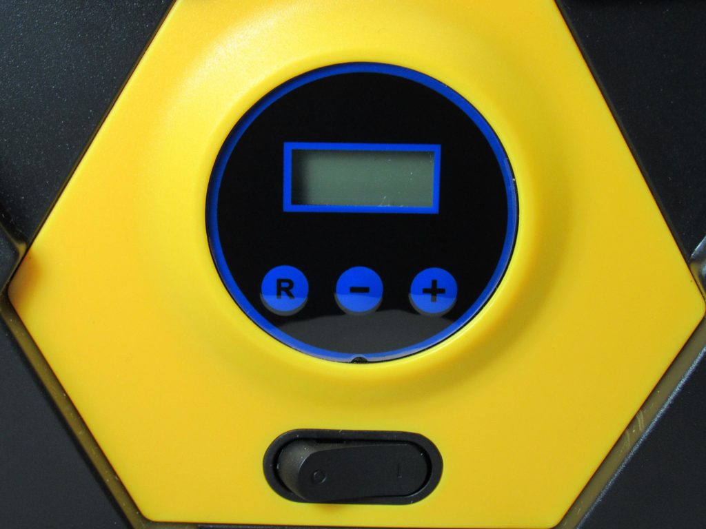 Close up of air compressor buttons and power switch